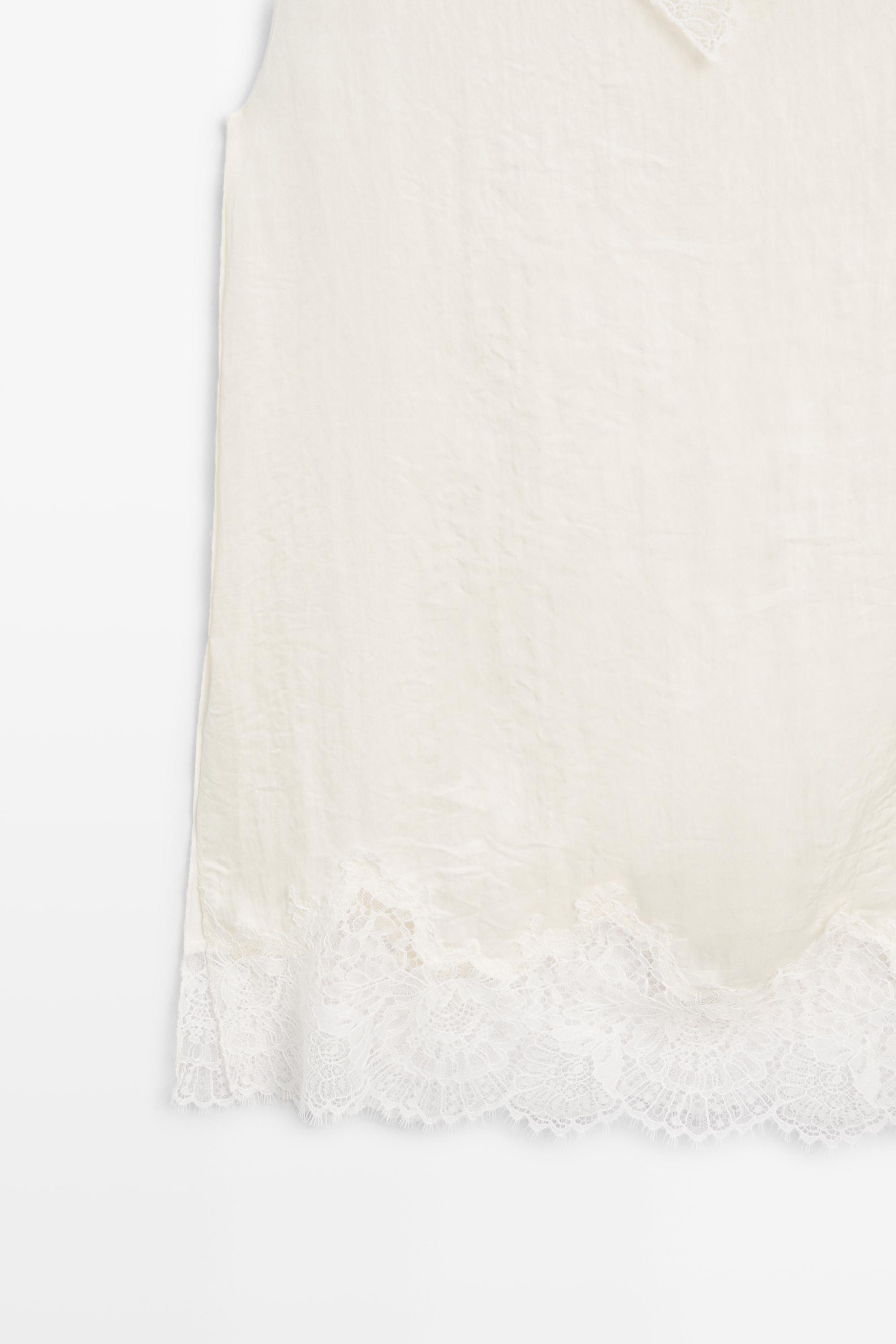 Asymmetric roll neck top with lace detail
